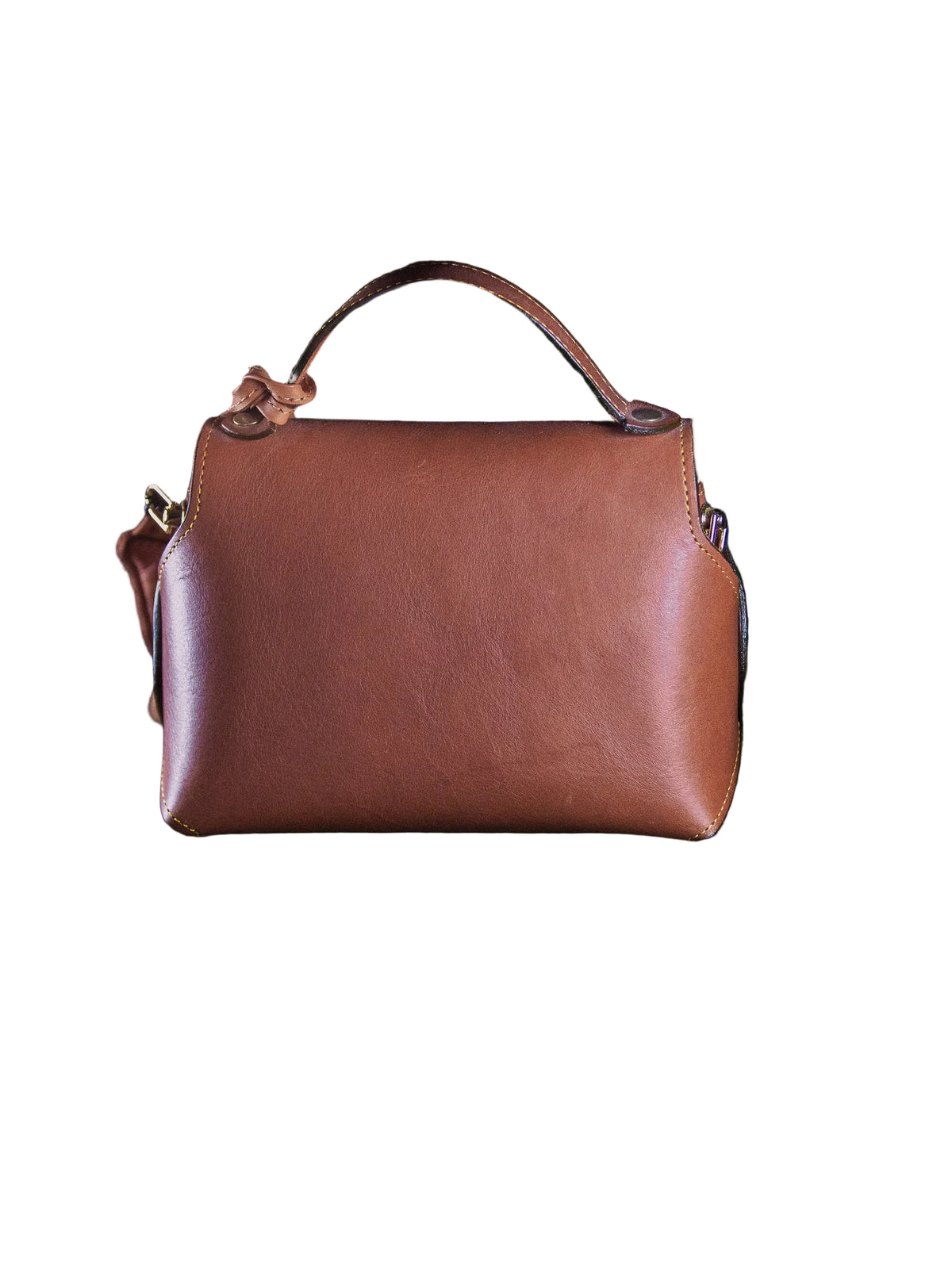 Brown leather handbag with a gold lock on a dark surface