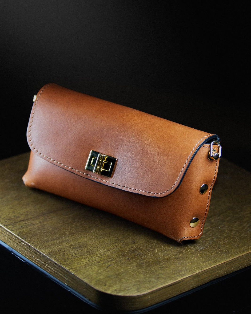 brown leather clutch bag from the side