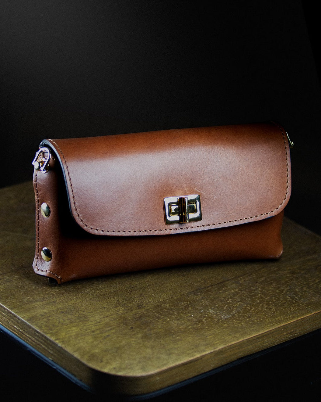 dark brown leather clutch bag