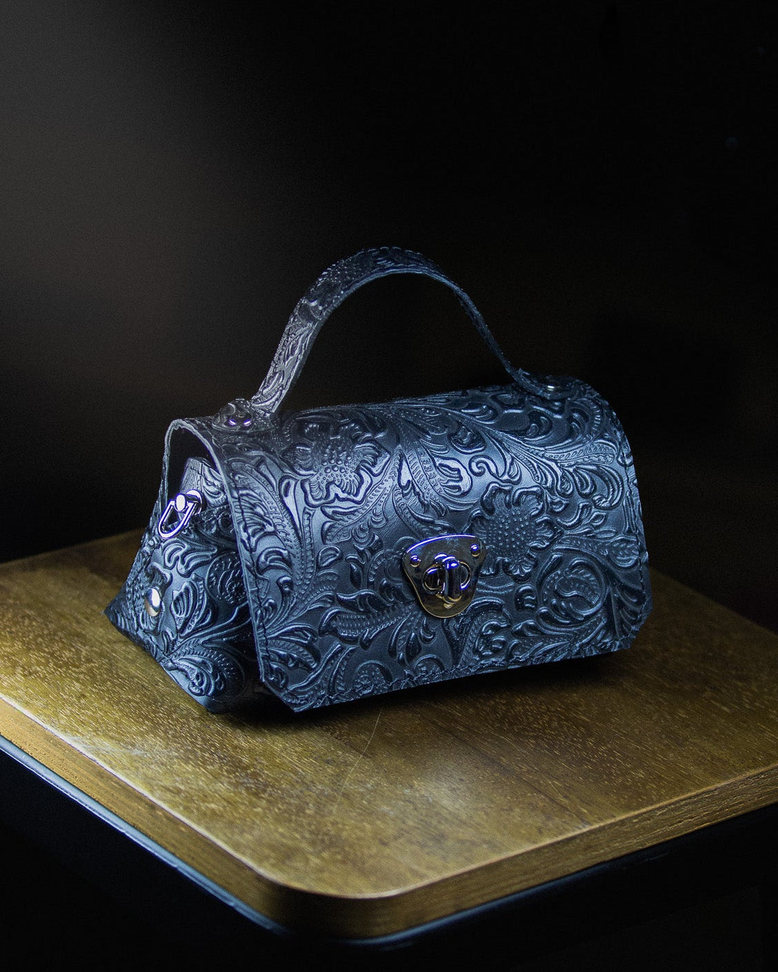 Decorative blue micro handbag with intricate patterns 