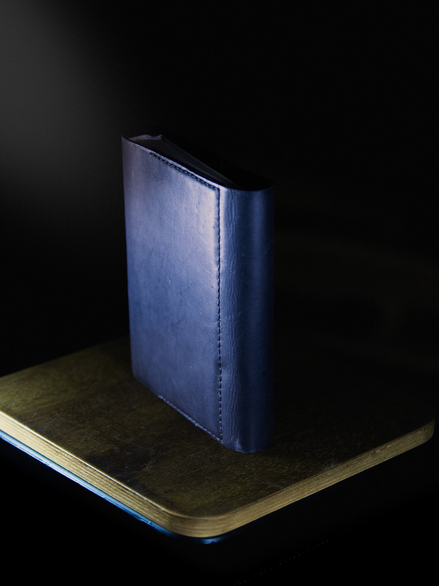 Blue leather-bound book on a dark background