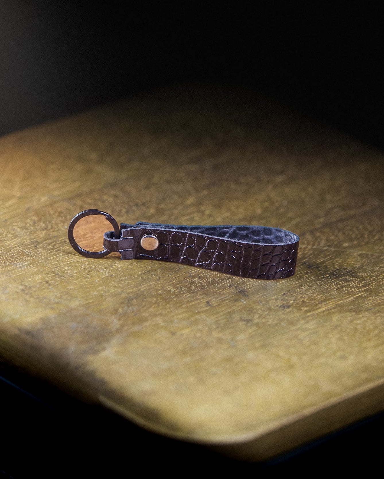 Captain's Keychain on a wooden surface and dark background