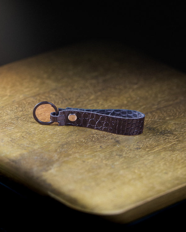 Captain's Keychain on a wooden surface and dark background
