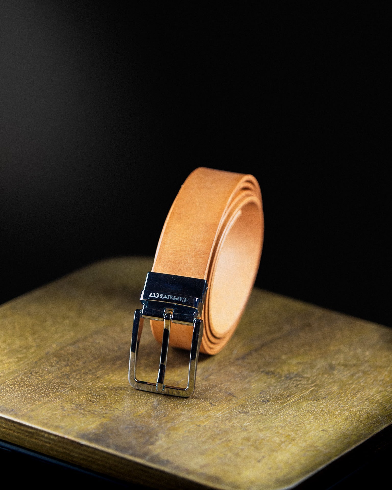 brown leather belt with black buckle