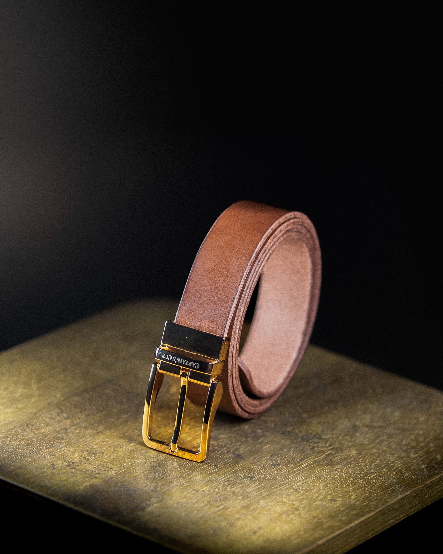brown leather belt with golden buckle