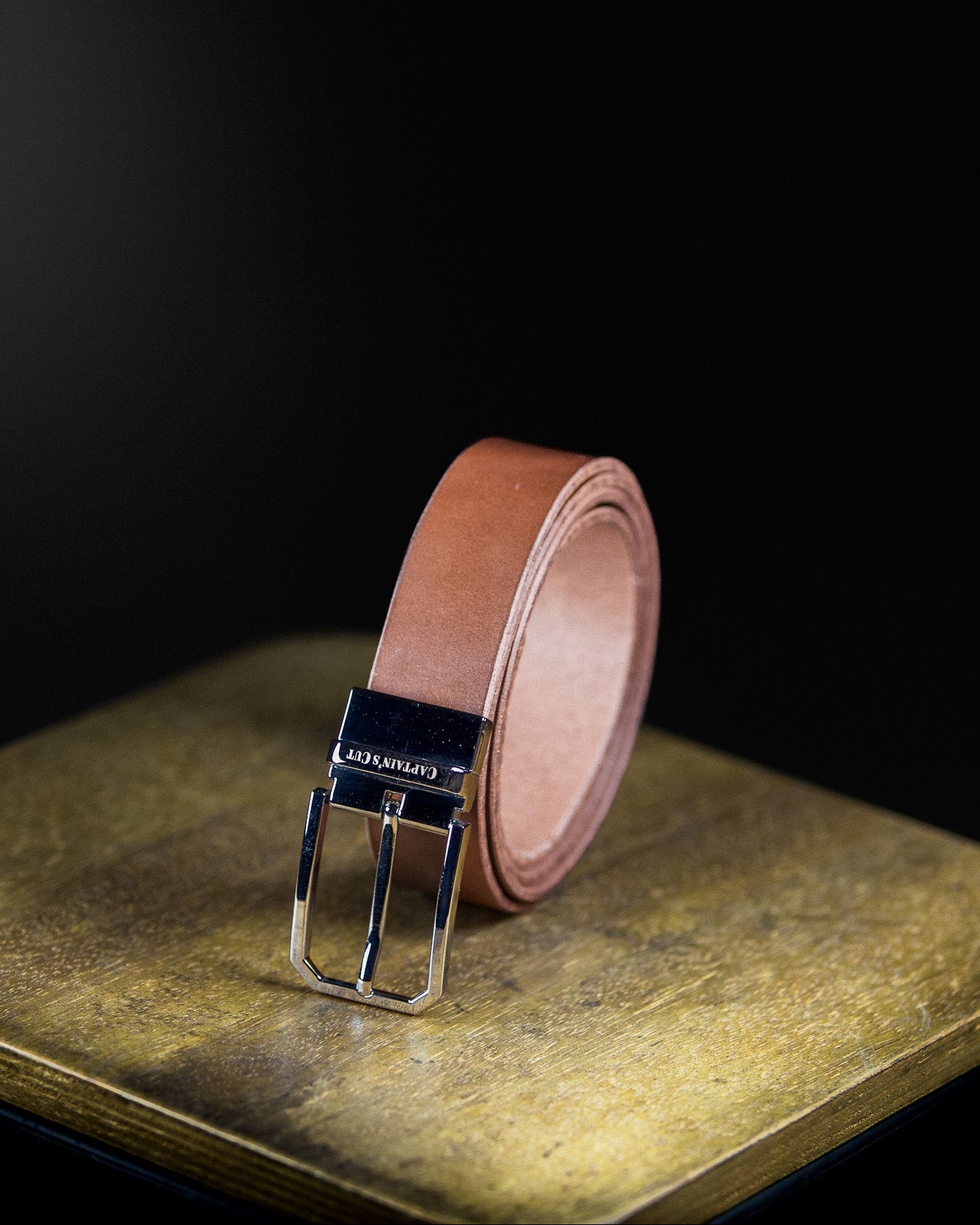 brown leather belt with silver buckle